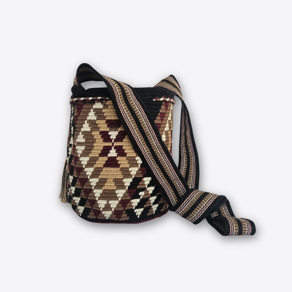 A handwoven bucket bag with a geometric diamond pattern in brown, beige, and black, featuring a wide woven shoulder strap, shown on a light gray background.
